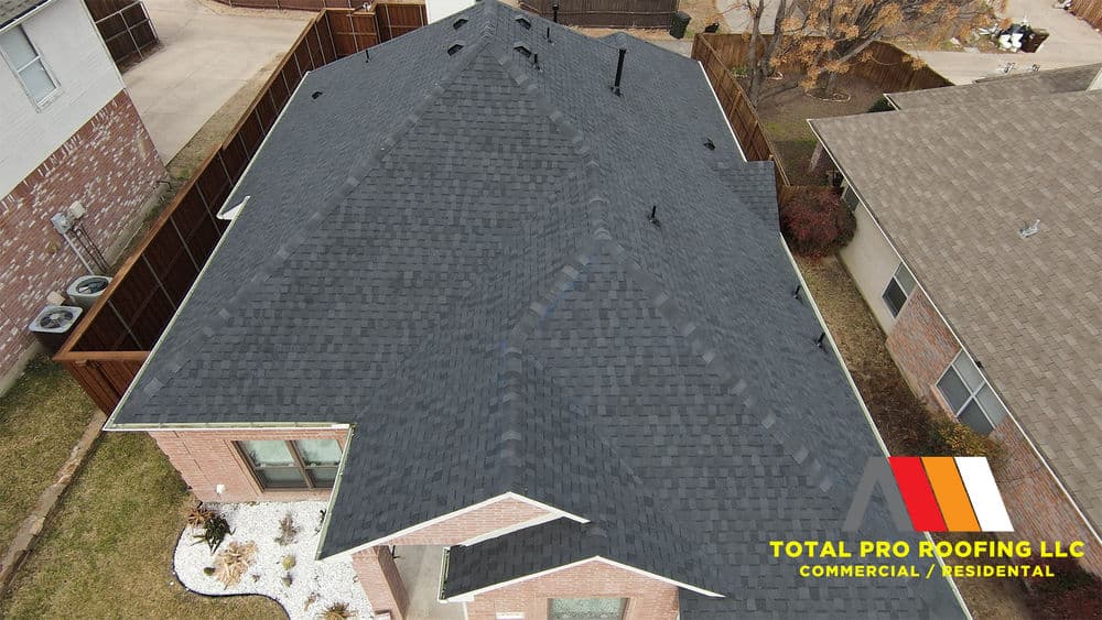 Drone view of a recently installed black shingle roof on a residential home. Total Pro Roofing LLC.