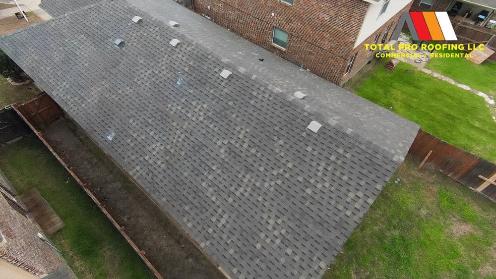 Aerial view of a well-maintained residential roof with shingles and Total Pro Roofing logo.