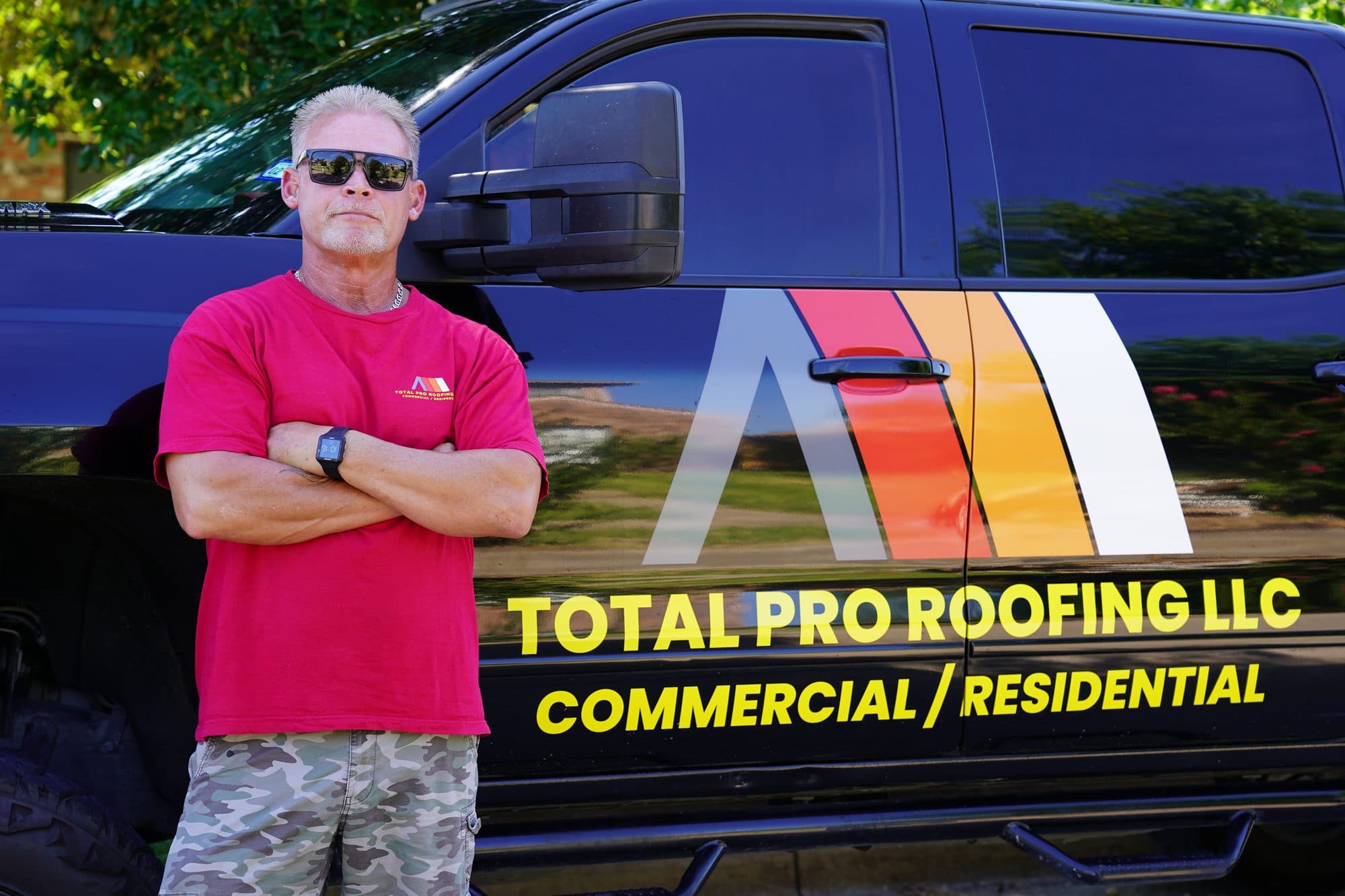 Duane Huddleston, owner of Total Pro Roofing, in front of the company truck